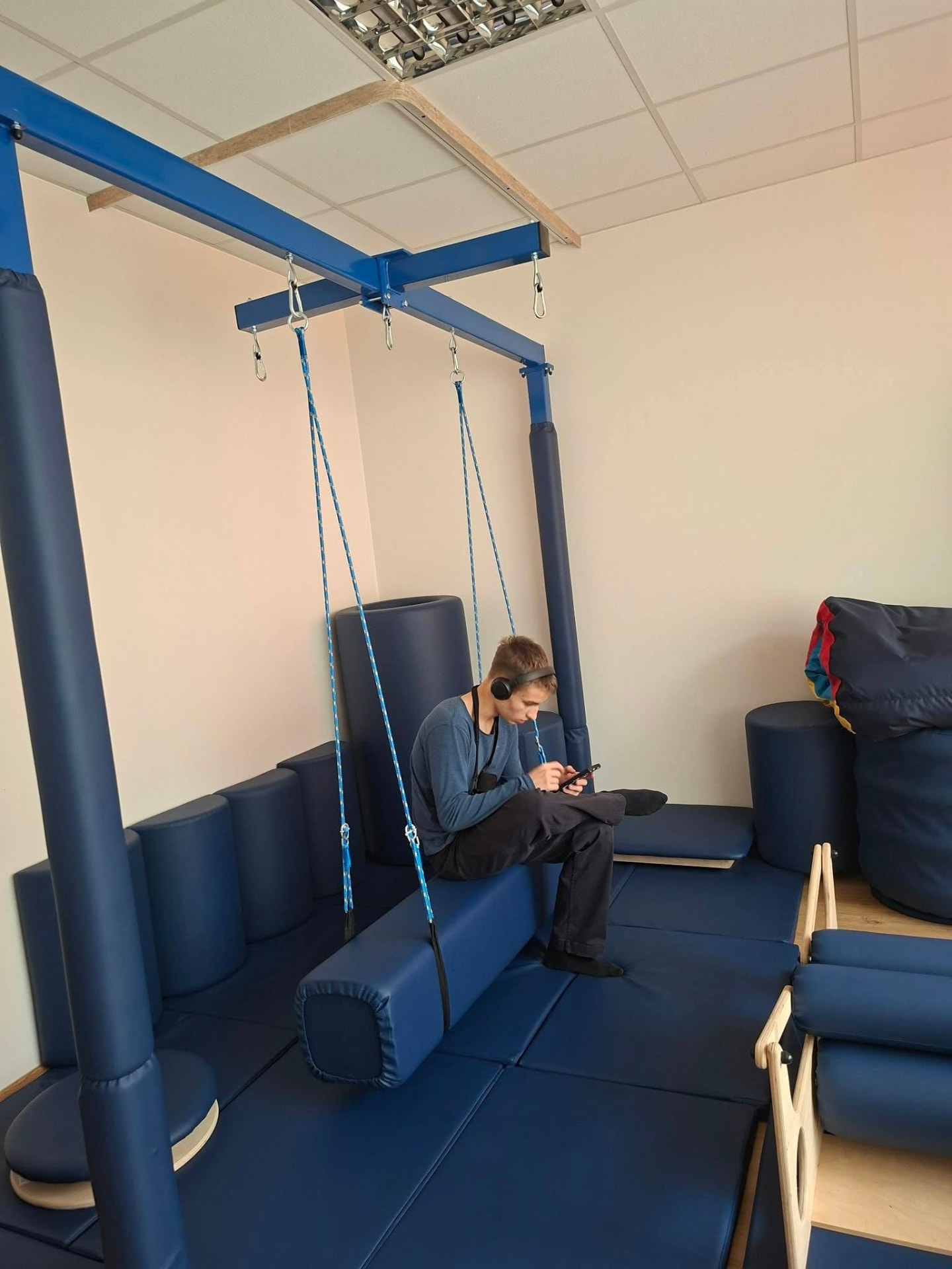 A young person relaxing on a therapy swing